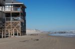 Just two miles north of Currituck Club, the paved road ends and 18 miles of beach road begins.  One home is literally in the ocean, at high tide.